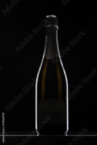 Brown Champagne bottle graphically presented on black background