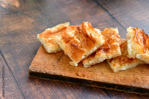 Bakery .Home made  cheese pie  with phyllo pastry and organic eggs. Bulgarian banitsa photo