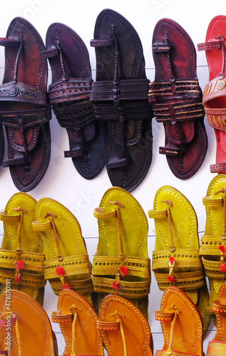 Colorful Handmade chappals (sandals) being sold in an Indian market, Handmade leather slippers, Traditional footwear. photo