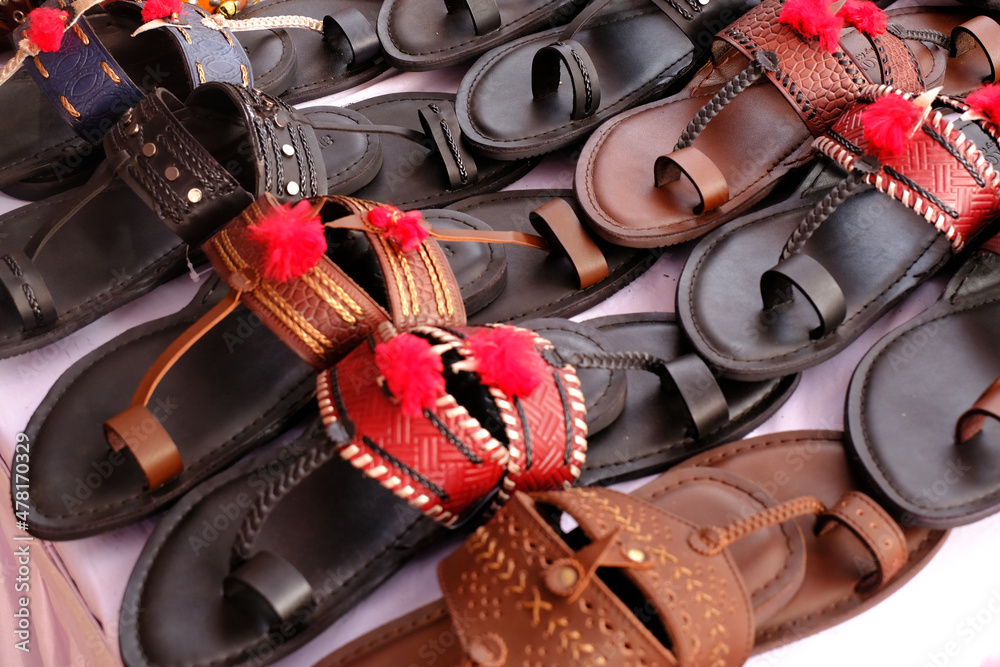 Colorful Handmade chappals (sandals) being sold in an Indian market,  Handmade leather slippers, Traditional footwear. Stock 写真 | Adobe Stock