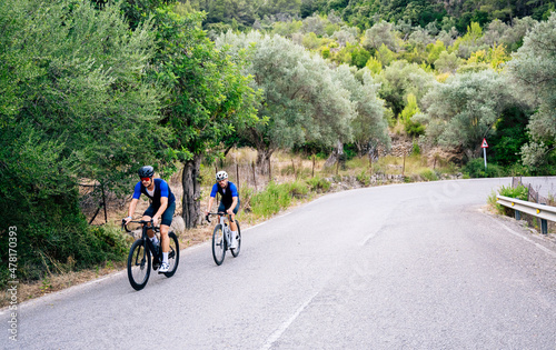 Two cyclists training on a mountain road. Cycling image with copy space. Healthy concept