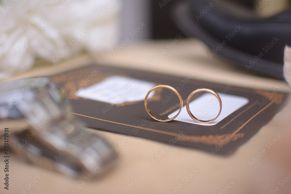 two wedding rings. Marriage symbol, attribute. Two gold wedding rings. Close-up view of a gold wedding ring. Two gold wedding rings in the bright sun two wedding rings. Marriage symbol, attribute. Two gold wedding rings. Close-up view of a gold wedding ring. Two gold wedding rings in the bright sun