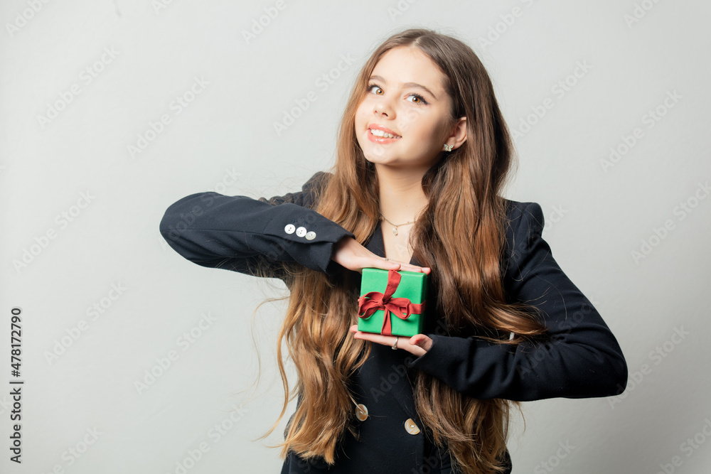 Young girl with little green gift box on white background. Young girl with little green gift box on white background.