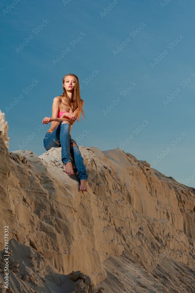 Girl in jeans on the sand..Girl in jeans on the sand.