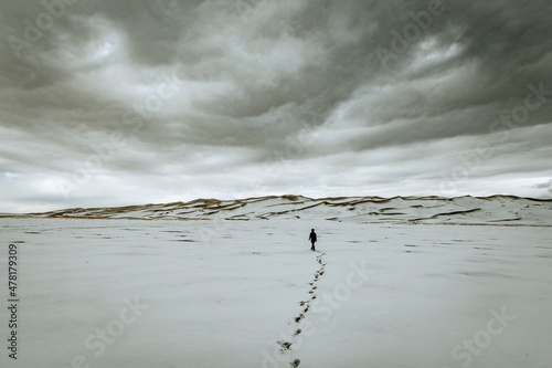 single person and footsteps clouds, sand dunes national park Colorado photo