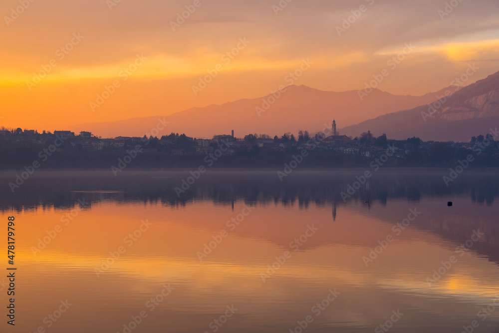 Fototapeta premium Dramatic Fire red clouds drift across a twilight sky just after sunset