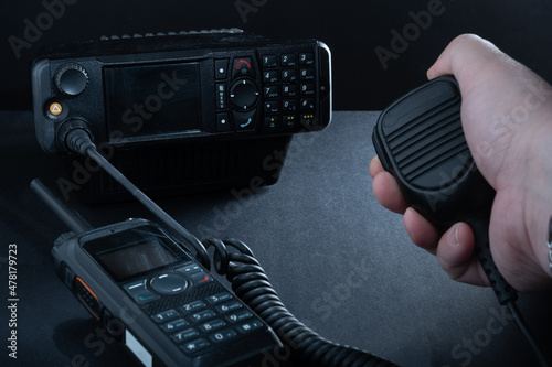 Closeup of pair of mobile two-way radios for Amateur radio operators against dark background. photo