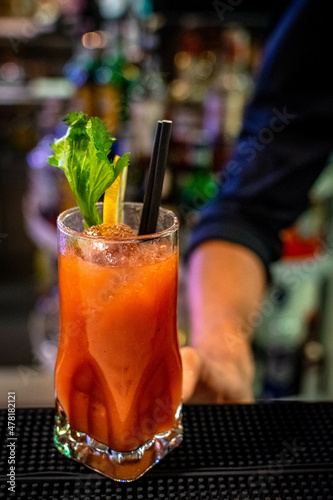 a bartender serving a bloody mary cocktail at a nightclub in Marbella 