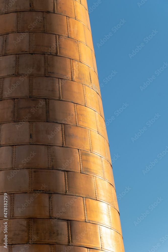 a abstract image of a copper covered lighthouse tower in the center of Marbella 