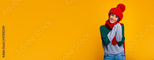 Big wide banner photo of happy young beautiful woman in red hat and scarf is posing isolated on yellow background