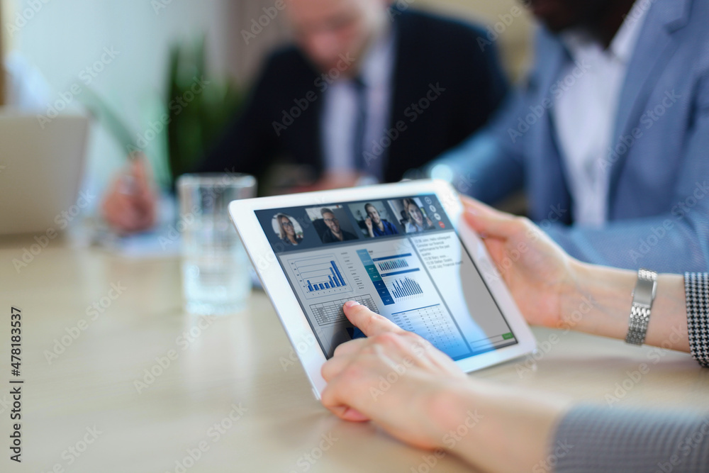 People meeting analyzing financial statistics in office. Group of business team having video conference with their team on digital tablet, remote work at home. People meeting analyzing financial statistics in office. Group of business team having video conference with their team on digital tablet, remote work at home.