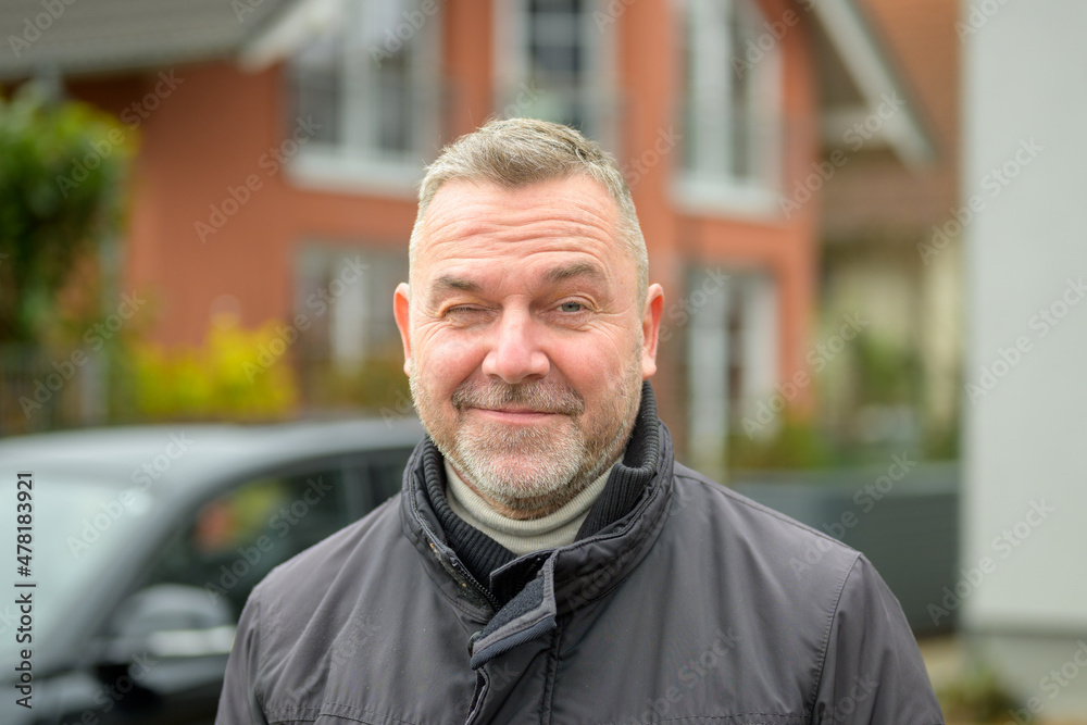 Smiling playful middle-aged man winking at camera Smiling playful middle-aged man winking at camera