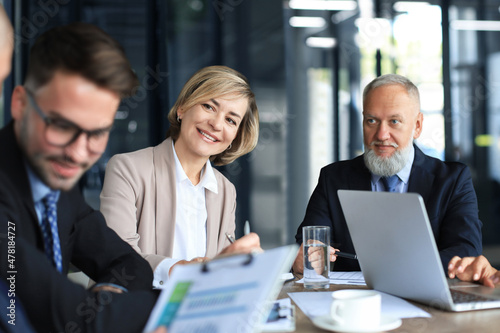 Group of business partners discussing ideas and planning work in office.