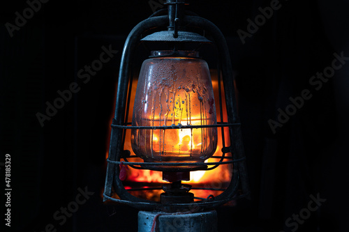 Vintage oil lamp.  Lantern in the dark room. Oil Lamp Lighting up the Darkness. photo