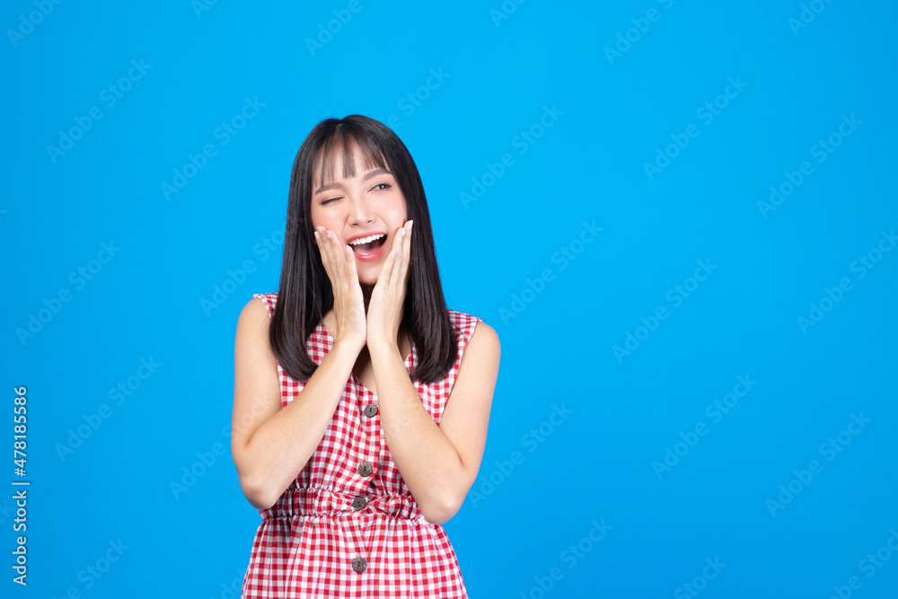 Portrait of beautiful young Asian girl model long hair in casual summer clothes smile, happy and enjoying in studio isolated on blue background. Portrait of beautiful young Asian girl model long hair in casual summer clothes smile, happy and enjoying in studio isolated on blue background.