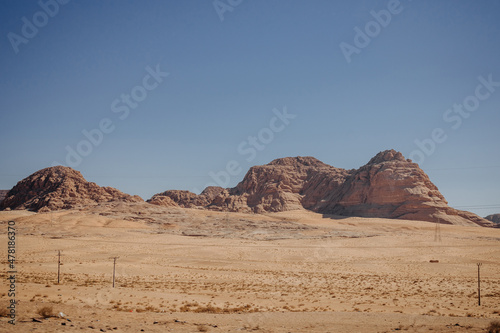 A picturesque mountain in the desert. Desert Wadi Rum with red sand. Landscape by the road. Jordan