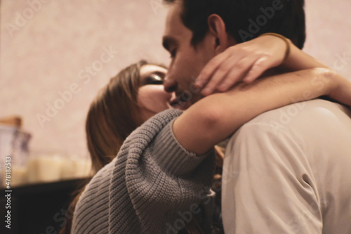 couple in love kissing inside. enamored guy and girl are hugging close-up. happy couple