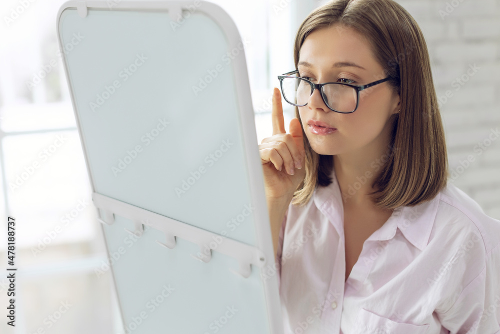 The woman chooses glasses for vision. High quality photo The woman chooses glasses for vision. High quality photo
