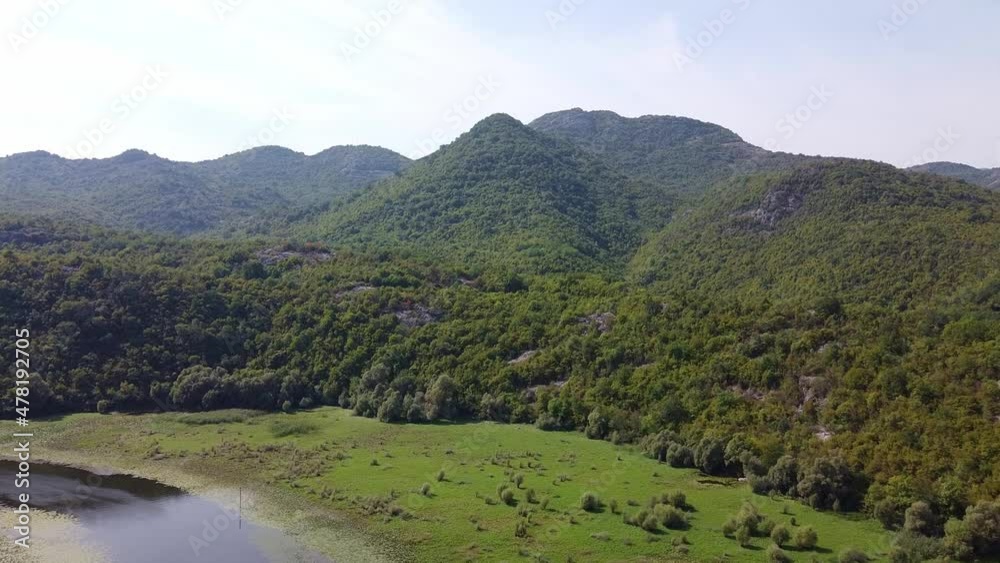The beauty of a mountain valley with long narrow river. Untouched nature. Aerial View of National Park Skadar Lake in Montenegro. The beauty of a mountain valley with long narrow river. Untouched nature. Aerial View of National Park Skadar Lake in Montenegro.