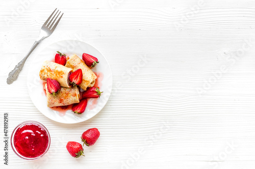 Hot french crepes with strawberry and berry sauce. Sweet dessert