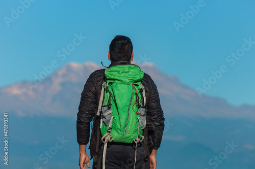 Man hiking at mountains with heavy backpack Travel Lifestyle wanderlust adventure