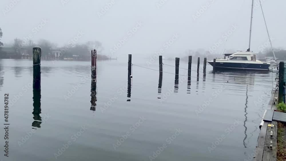Empty marina looks spooky with fog covering the water on a warm January morning on Long Island Empty marina looks spooky with fog covering the water on a warm January morning on Long Island