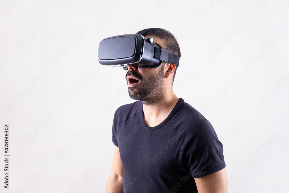 Young man in VR glasses headset excited surprised portrait. Virtual reality, future technology, education video gaming Young man in VR glasses headset excited surprised portrait. Virtual reality, future technology, education video gaming