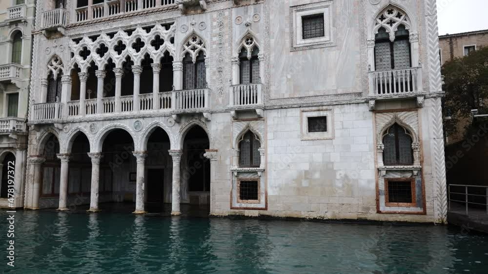 Venice, Italy - Sailing along the Grand Canal among the historic buildings of the lagoon city on a cloudy winter day Venice, Italy - Sailing along the Grand Canal among the historic buildings of the lagoon city on a cloudy winter day