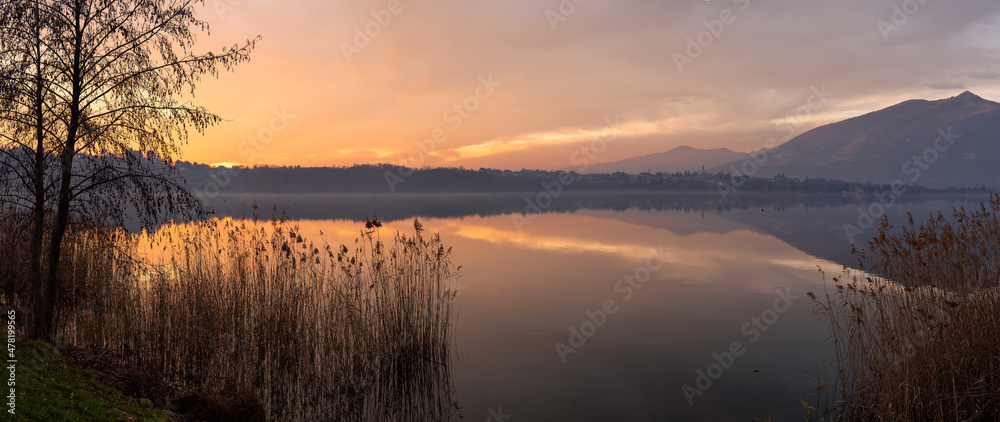 Sunset over the lake with beautiful sky and landscape reflections
