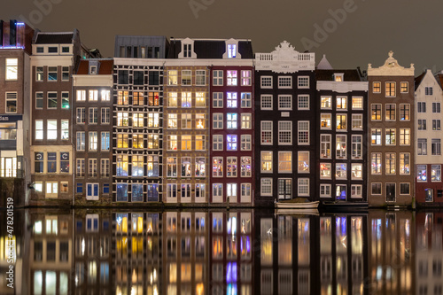 Night view of iconic ancient medieval buildings in the Old Town of Amsterdam, Netherlands