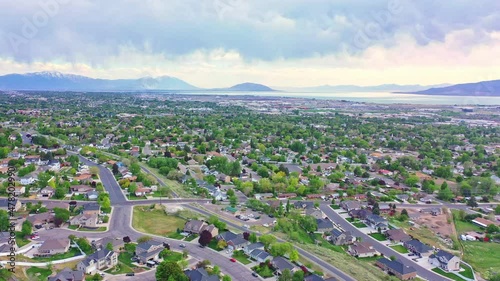 Aerial over Pleasant Grove Utah, late spring evening sunset with clouds and lake
