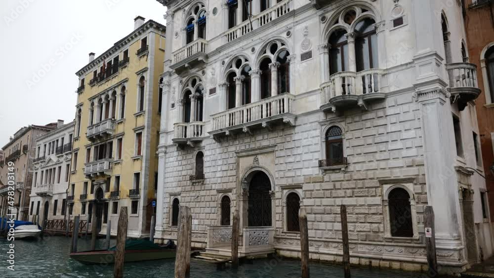 Venice, Italy - Sailing along the Grand Canal among the historic buildings of the lagoon city on a cloudy winter day Venice, Italy - Sailing along the Grand Canal among the historic buildings of the lagoon city on a cloudy winter day
