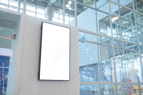 Vertical blank digital interactive white display wall at exhibition or museum with futuristic scifi interior. White screen, mock up, future, copyspace, template, technology concept