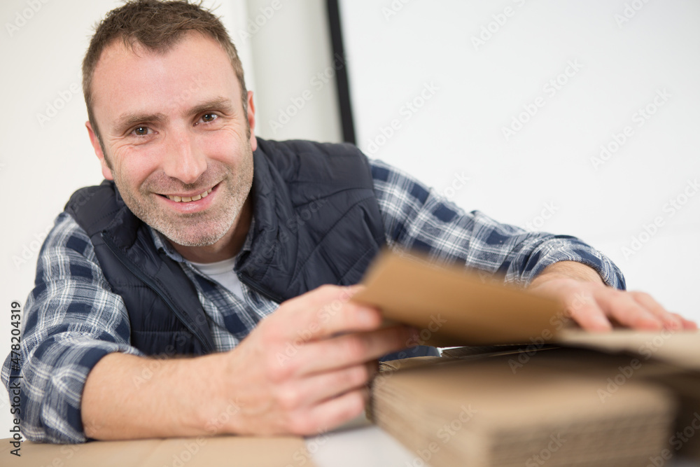 delivery man with cardboard box in hands delivery man with cardboard box in hands