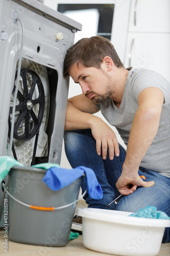 man fixing a washing machine