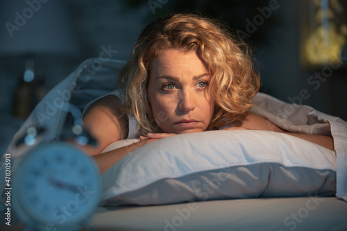 Fotografia depressed woman laying awake at night