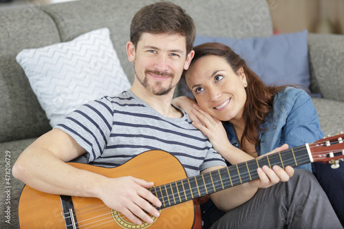 man playing guitar for her wife
