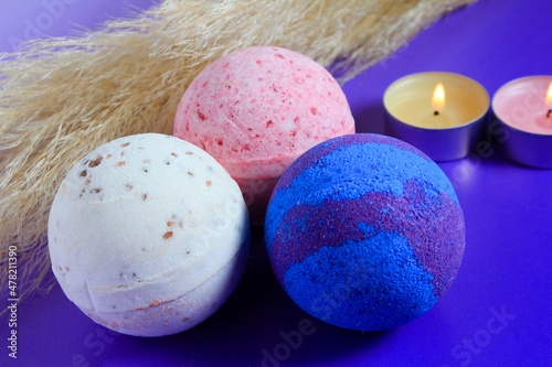 bath bomb and arom candles on colorful background. Spa set, body care, background. photo
