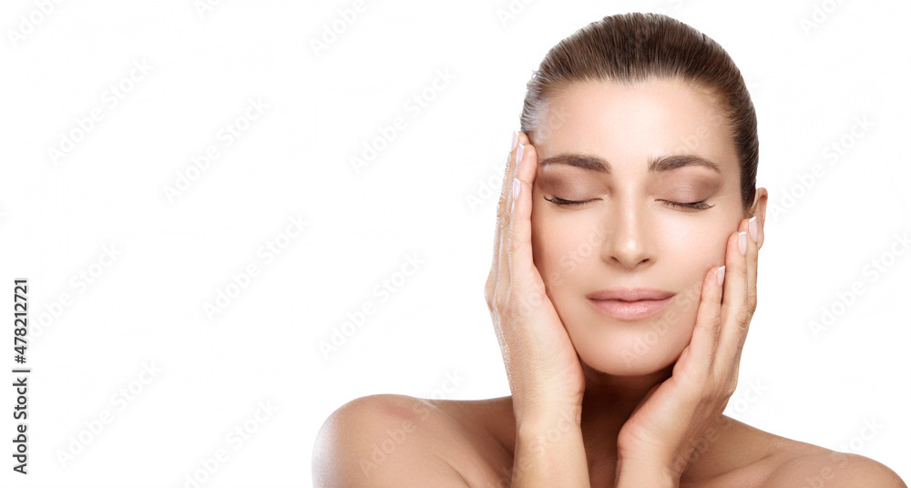 Makeup and skin care concept. Beautiful brunette woman with natural makeup and glowing hydrated skin touching her face. Natural beauty with perfect healthy skin tone and fresh skin isolated on white Makeup and skin care concept. Beautiful brunette woman with natural makeup and glowing hydrated skin touching her face. Natural beauty with perfect healthy skin tone and fresh skin isolated on white