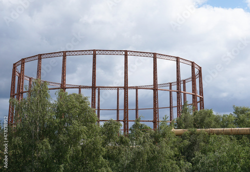 Old gas structure at former gas works site. Gas pipeline and empty storage cylinder photo