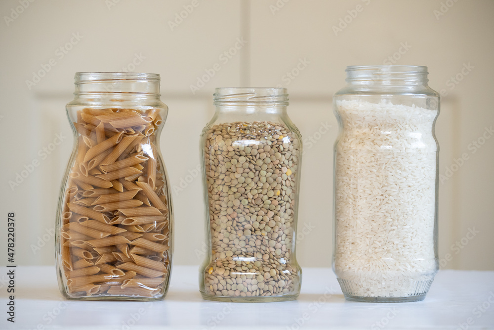 Front view of three glass jars with foodstuffs Front view of three glass jars with foodstuffs