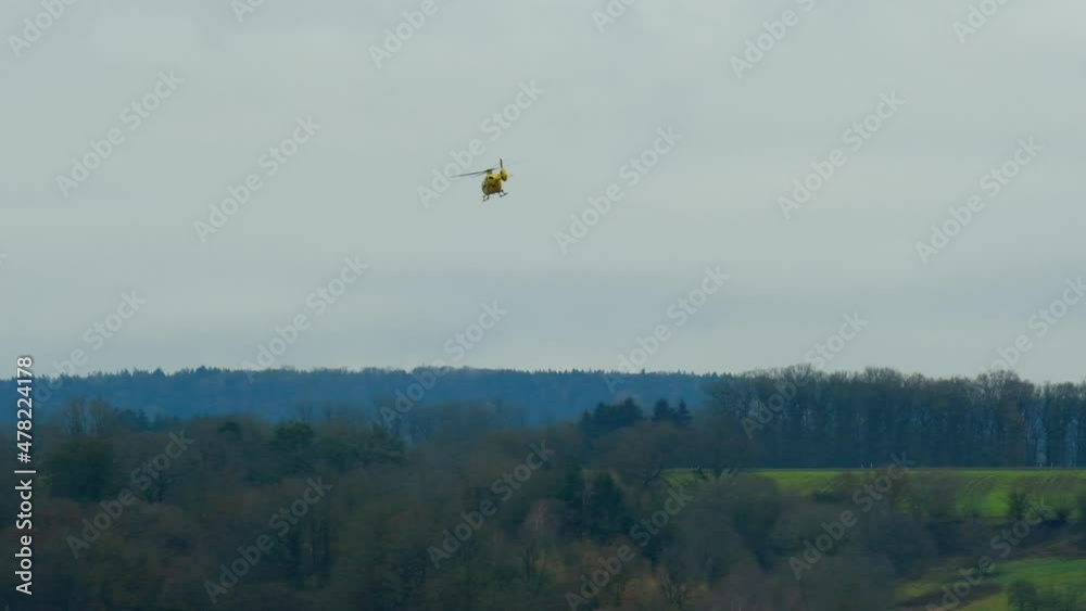 Helicopter.Air transport. Ambulance medical helicopter. Yellow helicopter takes to the sky over mountains and fields. 4k footage Helicopter.Air transport. Ambulance medical helicopter. Yellow helicopter takes to the sky over mountains and fields. 4k footage
