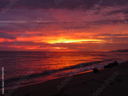 Pink, orange, and purple landscape of a sunsetting in one of the beaches of the Atlantic coast in Colombia photo