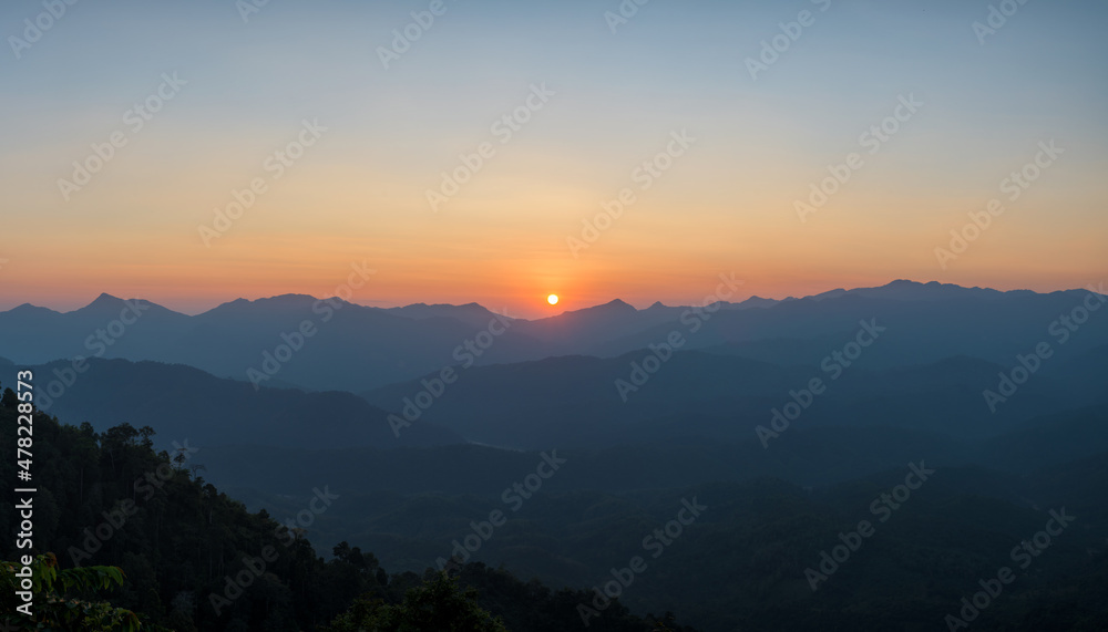 Panoramic beautiful sunset landscape from the forest in the national park on top mountain.