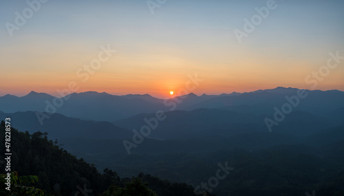 Panoramic beautiful sunset landscape from the forest in the national park on top mountain. © yotrakbutda
