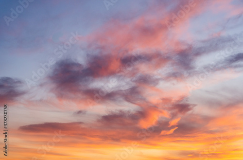 Colorful sky with clouds in the evening. Cloudscape, sunset time. Orange, pink, purple, yellow clouds on blue sky