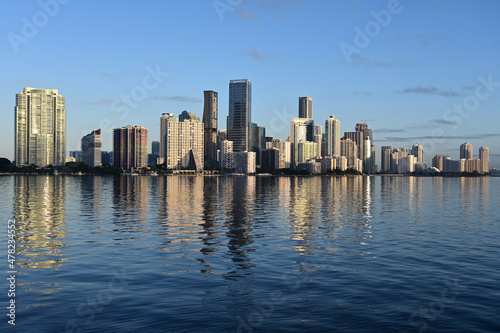 City of Miami skyline reflected on tranquil water of Bisvcayne Bay in early morning light on calm clear winter day. © Francisco