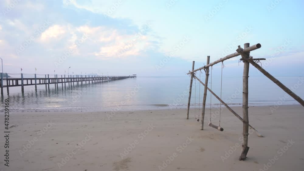 Lomprayah Pier And Wooden Swing At The Beach In Koh Samui, Thailand. - wide shot Lomprayah Pier And Wooden Swing At The Beach In Koh Samui, Thailand. - wide shot