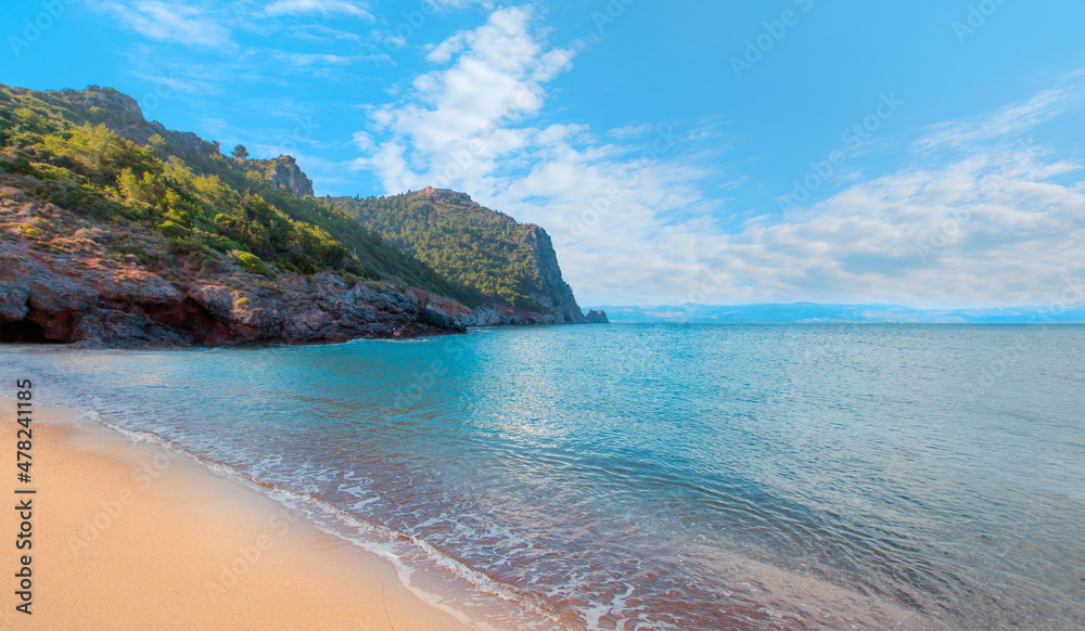 Fototapeta premium Cleopatra sand beach among rocks on evening sunset - Alanya, Turkey 