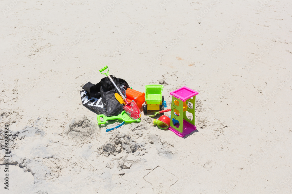 children is beach toys on sand on a sunny day